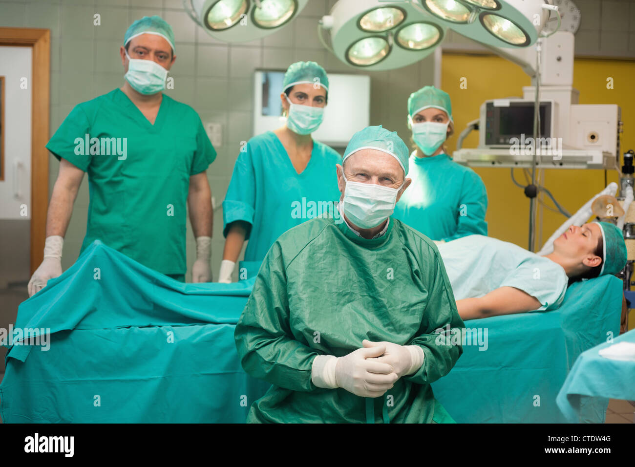 Surgical team around a patient Stock Photo