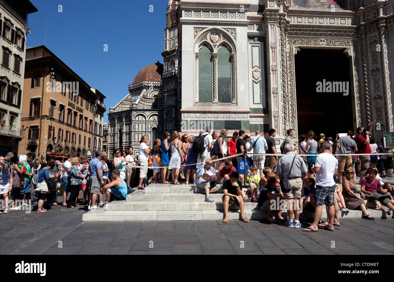 Tourists queue to enter Il Duomo in Florence, Italy Stock Photo