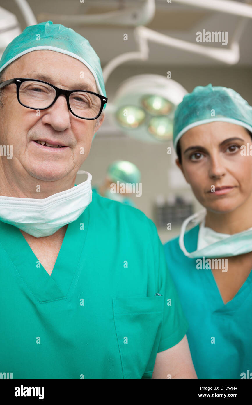 Surgeon with glasses on and a colleague Stock Photo Alamy