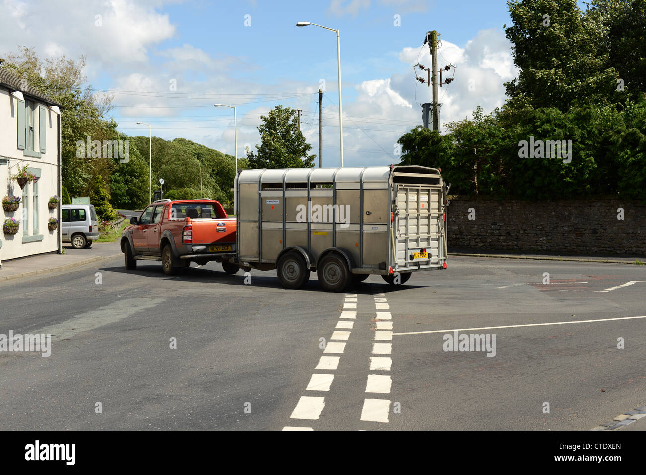 Horse box towed by pick up truck turning right at a junction. UK Stock Photo