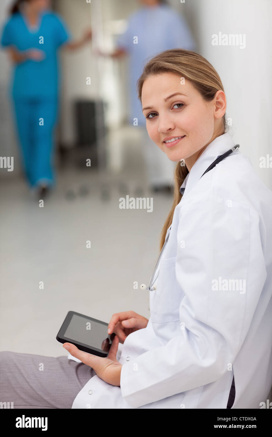 Doctor sitting tablet woman hi-res stock photography and images - Alamy