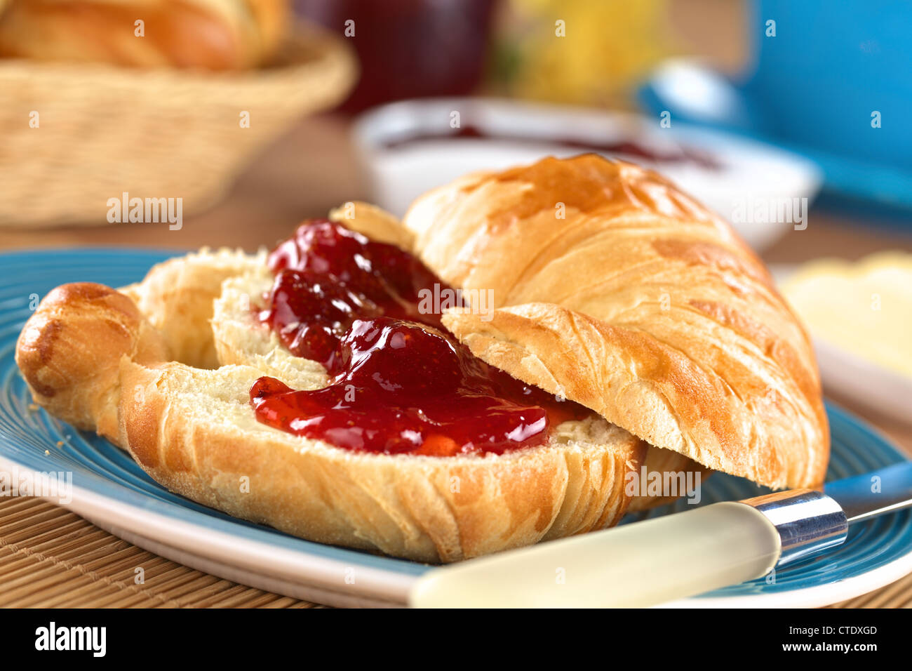 Croissant with butter and strawberry jam Stock Photo Alamy