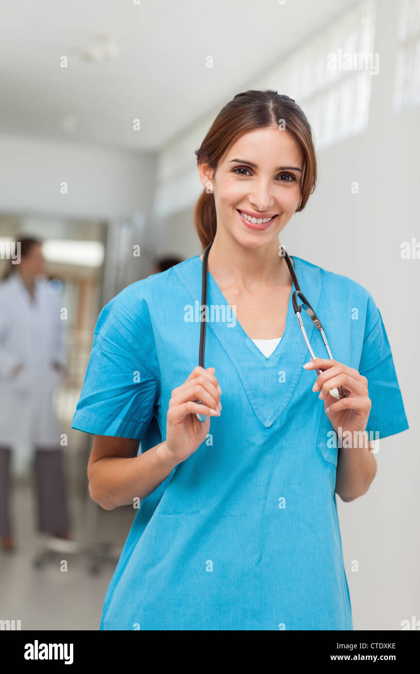 Nurse holding a stethoscope around her neck Stock Photo Alamy