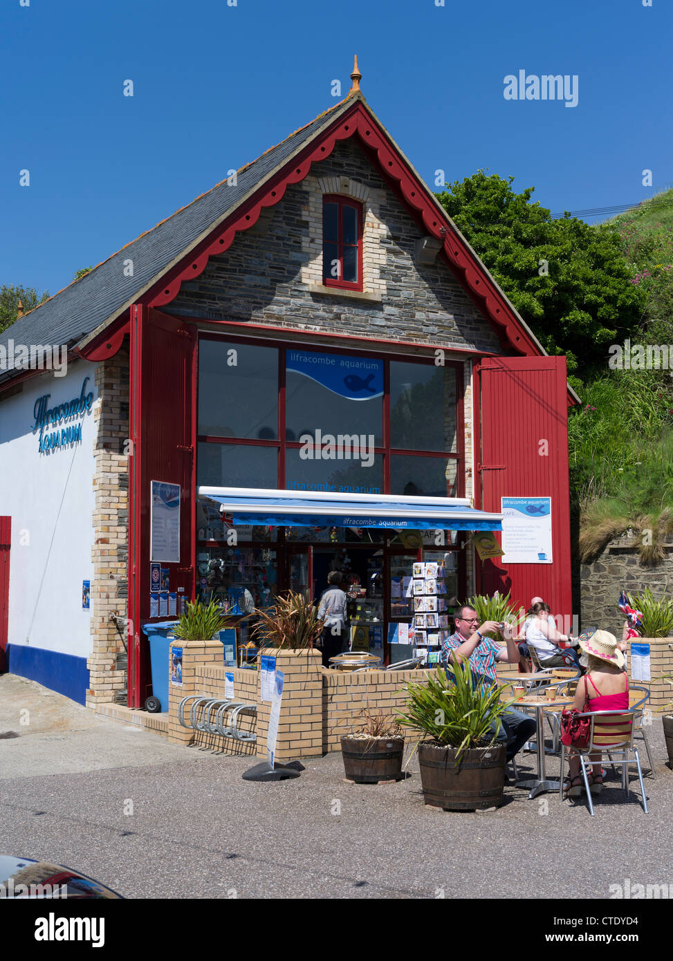 dh  ILFRACOMBE DEVON Aquarium people sitting relaxing outside cafe british seaside uk outdoor cafes gb Stock Photo