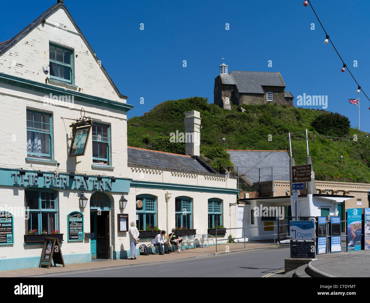 dh Ilfracombe harbour ILFRACOMBE DEVON English public house front The Pier Tavern seafront pub St Nicholas Chapel pubs Stock Photo