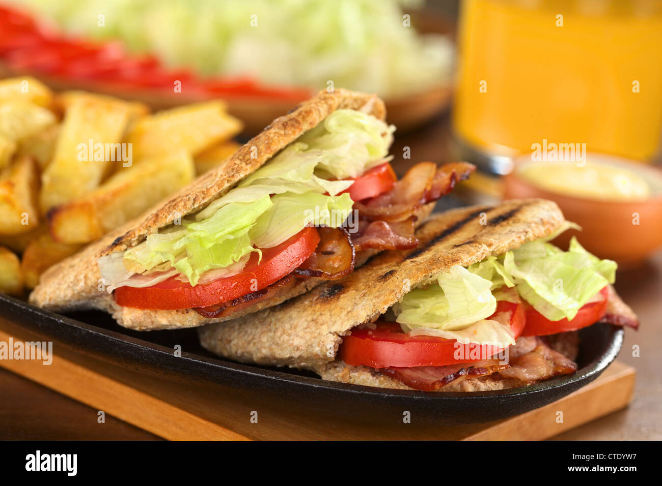 BLT (bacon, lettuce, tomato) wholewheat pita sandwich with French fries Stock Photo