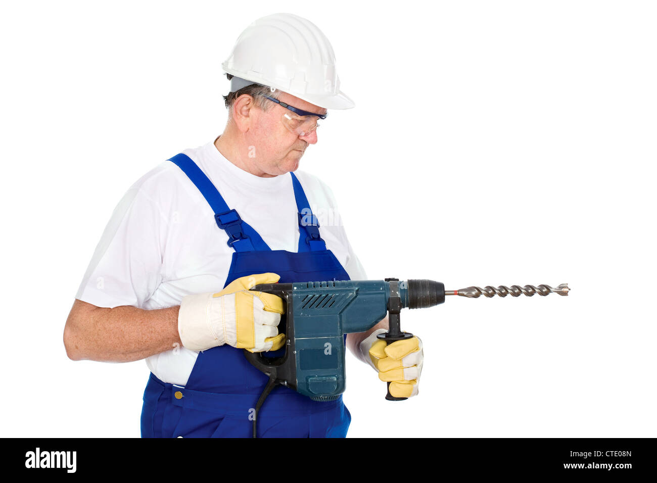 A construction worker holding drill for concrete and wearing proper ...