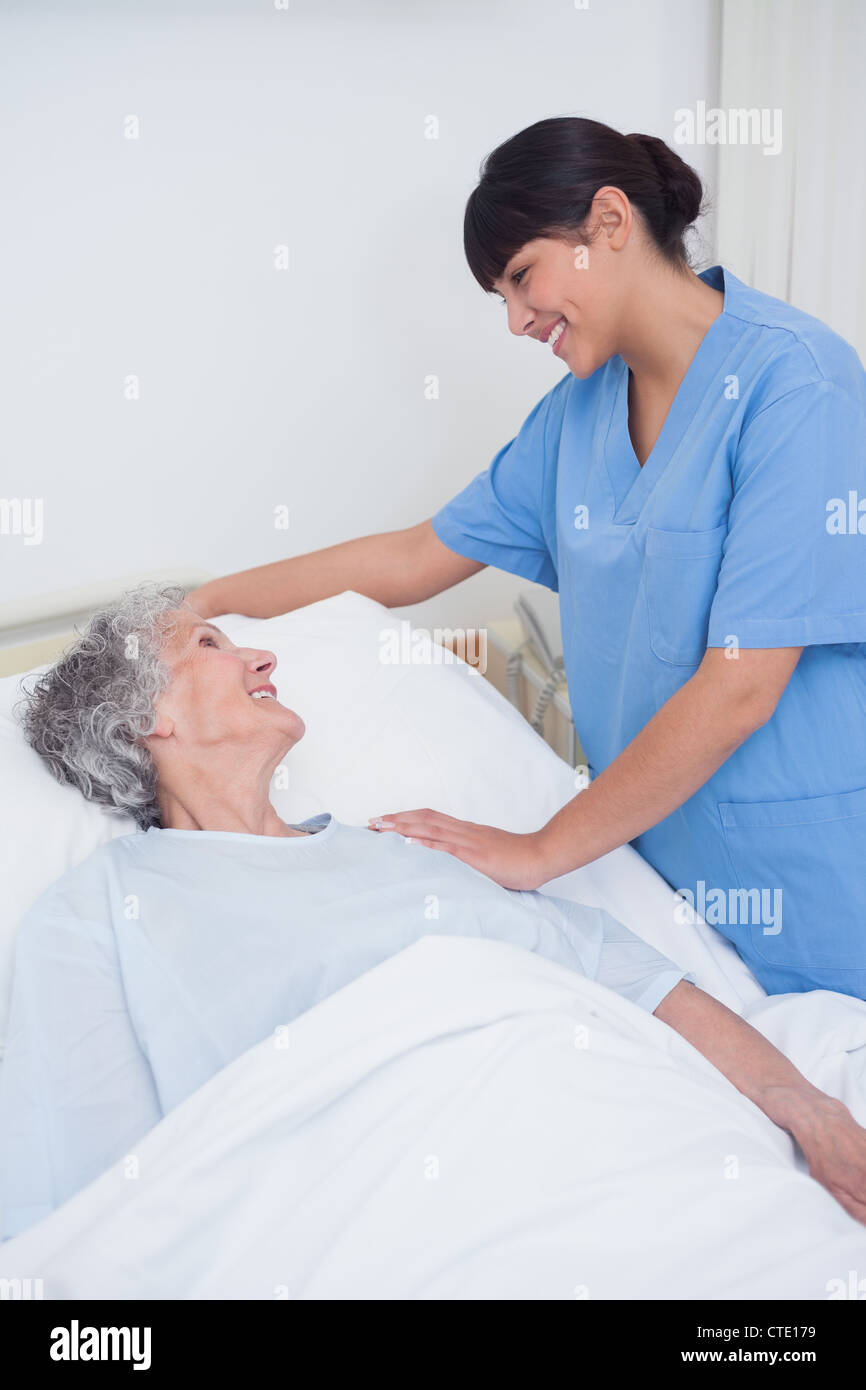 Nurse touching the shoulder of a patient Stock Photo Alamy