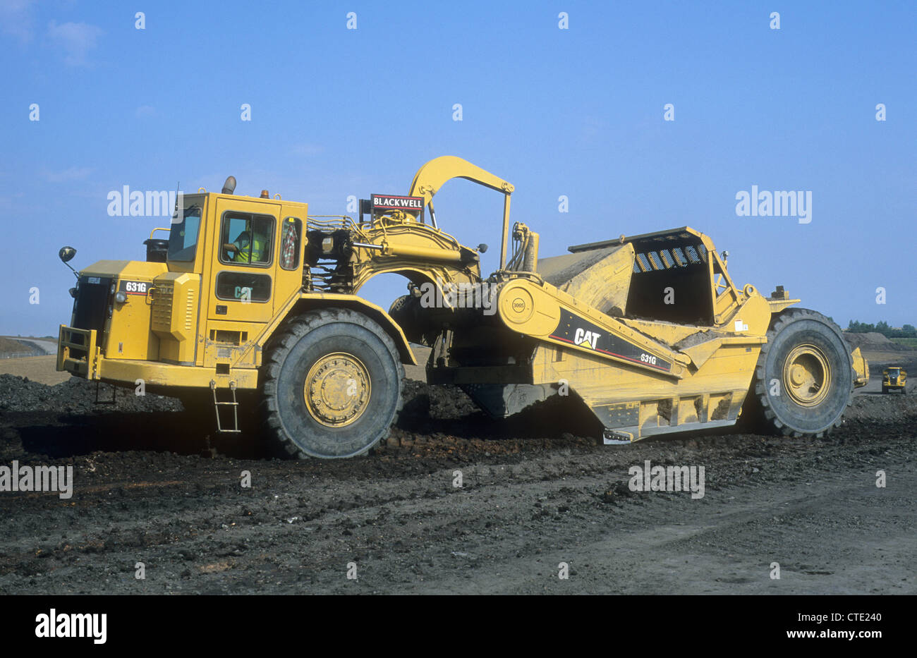 A Caterpillar-631G Land-Scraper Vehicle journeying Upon a land  reclamation-site to return wasteland into an open public park Stock Photo -  Alamy