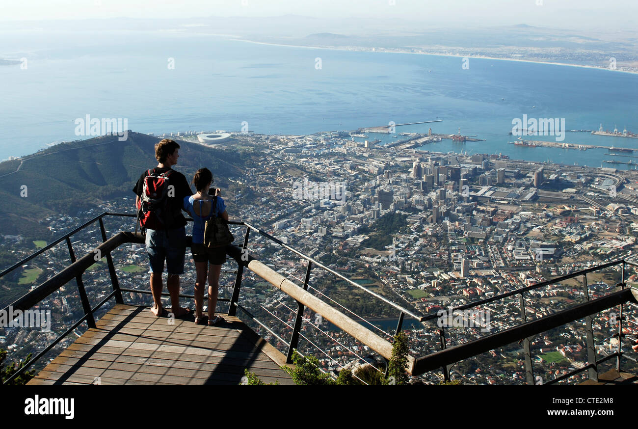 A man and woman look out over Cape Town and Table Bay from Table Mountain. Western Cape, South Africa Stock Photo