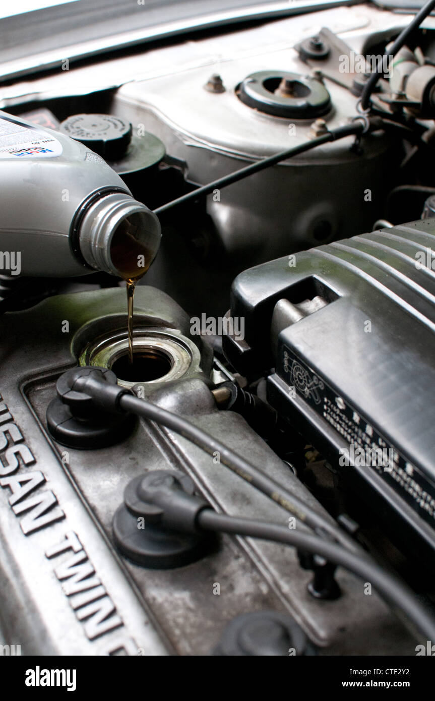 Topping up car engine oil Stock Photo