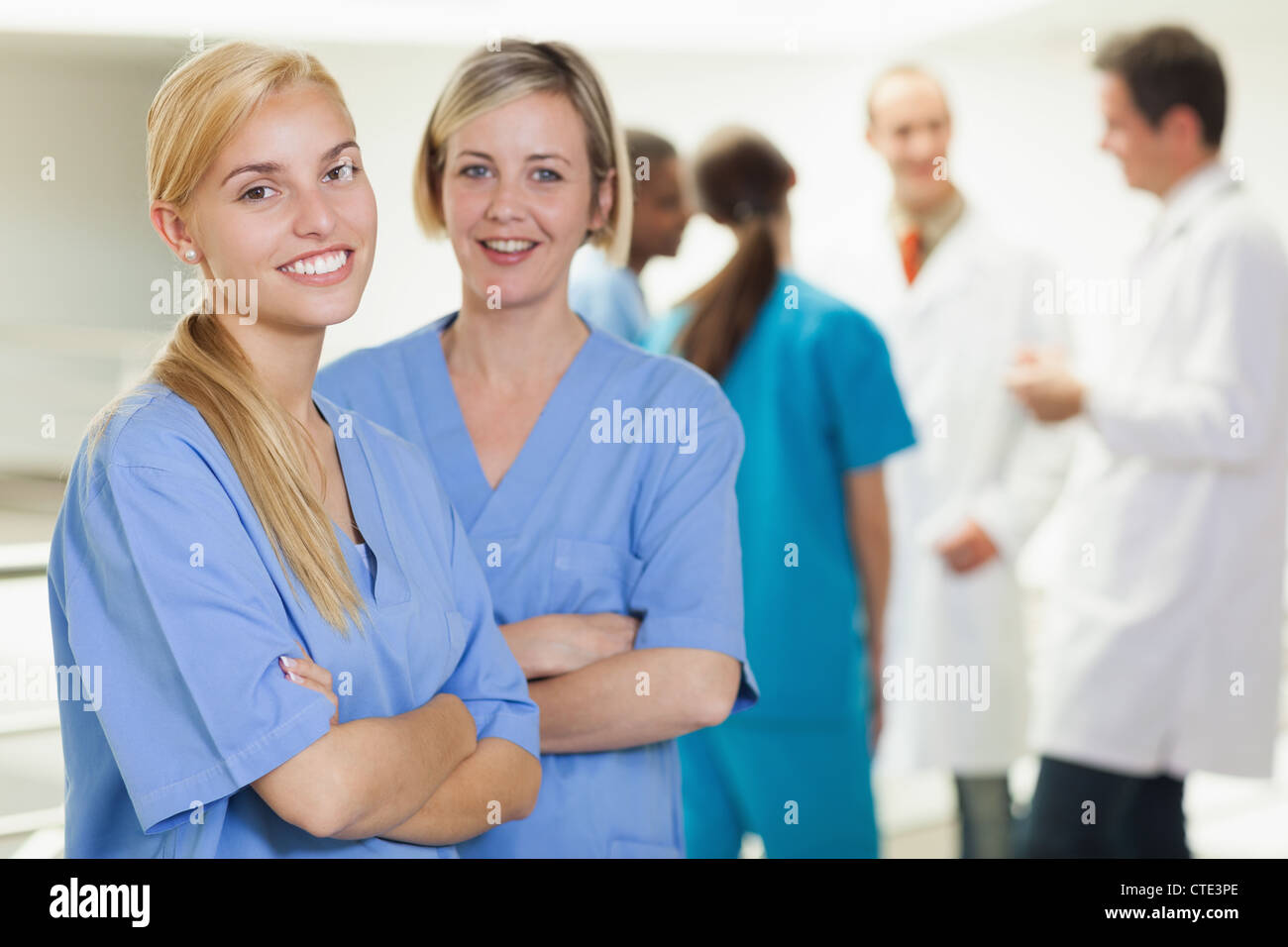 Nurses looking at camera while smiling Stock Photo