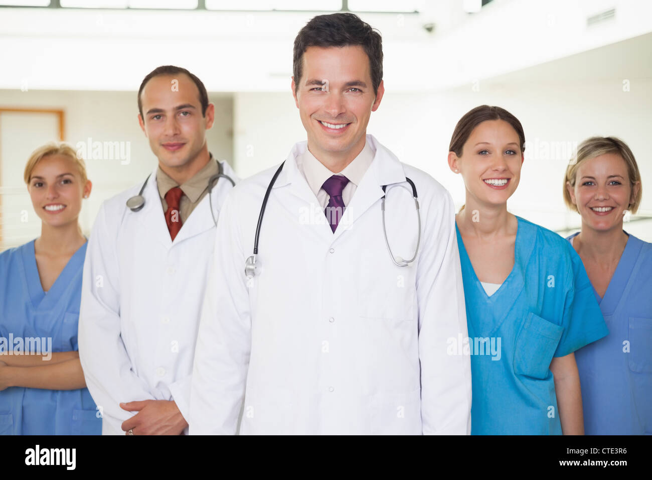 Doctors with nurses looking at camera Stock Photo