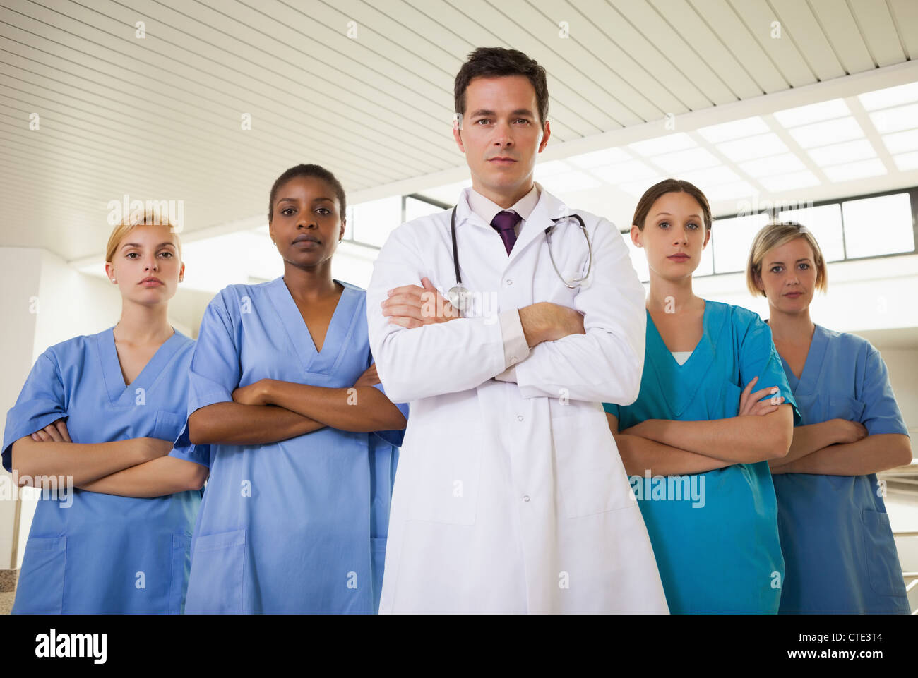 Doctor and nurses with arms crossed Stock Photo