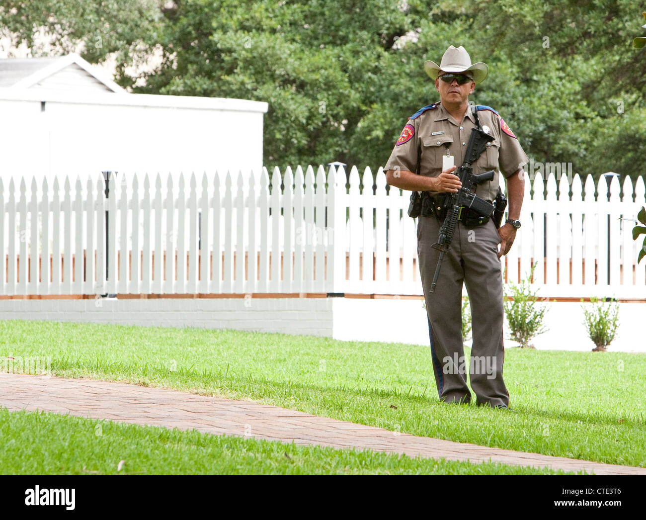 Officers with the Texas Department of Public Safety carry large weapons while on the Texas Governor's Mansion grounds. Stock Photo