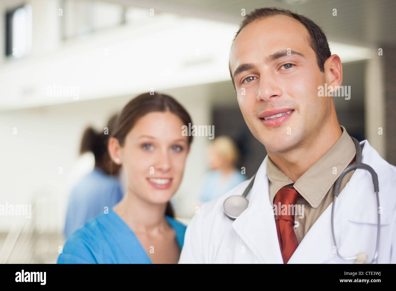 Doctor and nurse looking at camera Stock Photo - Alamy