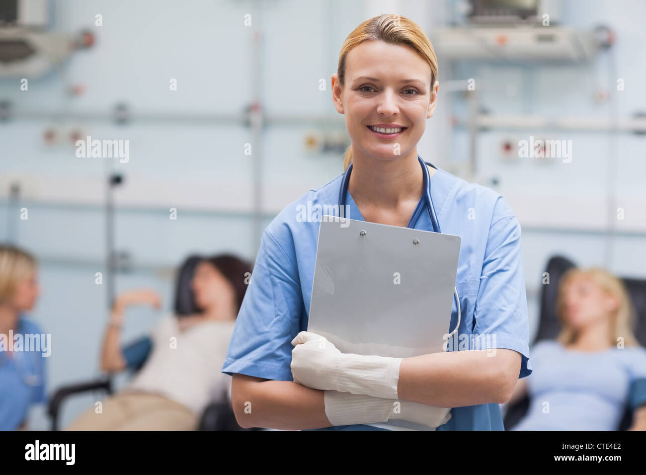 Smiling nurse holding a clipboard Stock Photo - Alamy