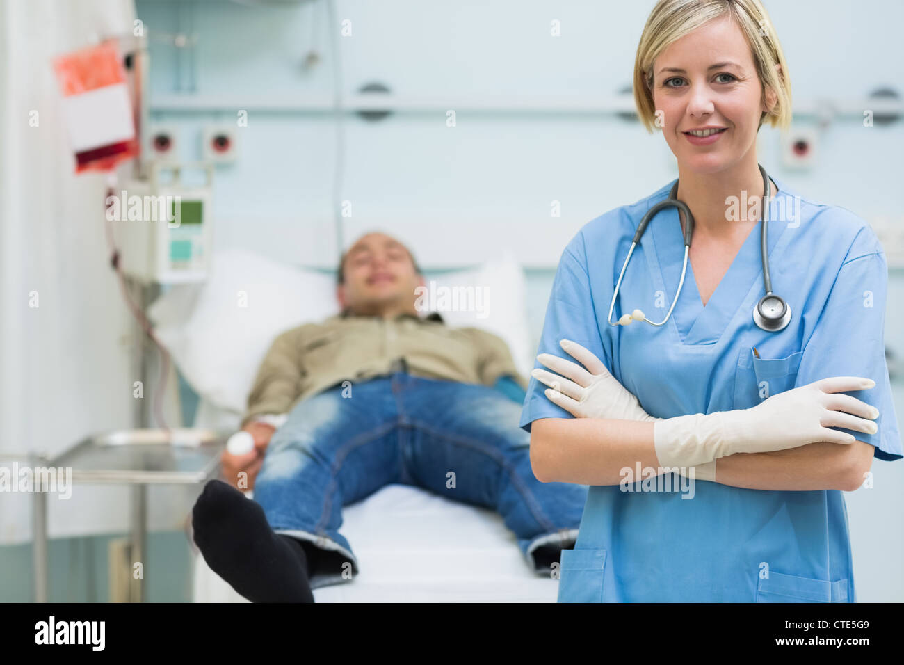 Nurse next to a male patient with arms crossed Stock Photo