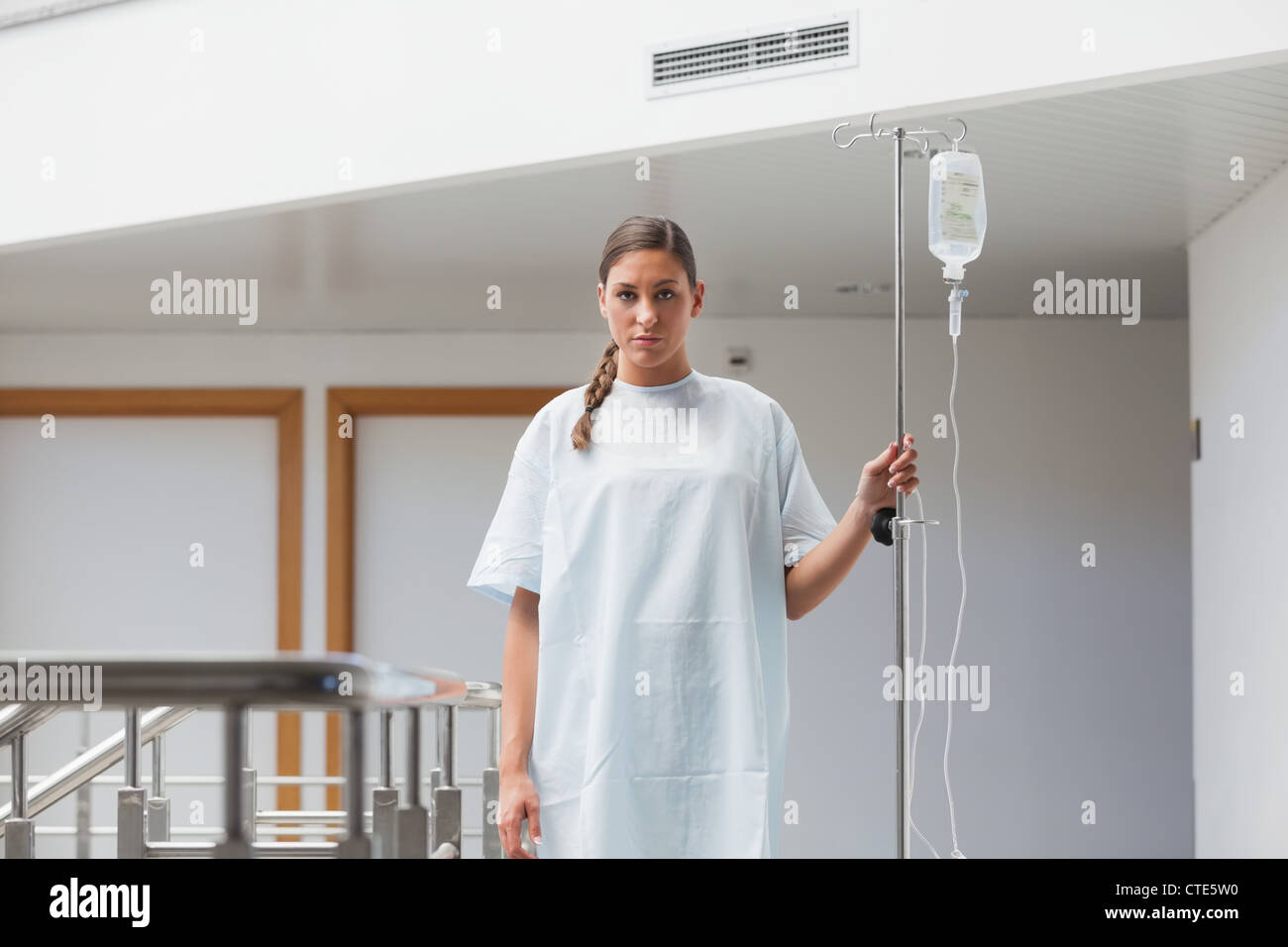 Female patient walking with a drip stand Stock Photo