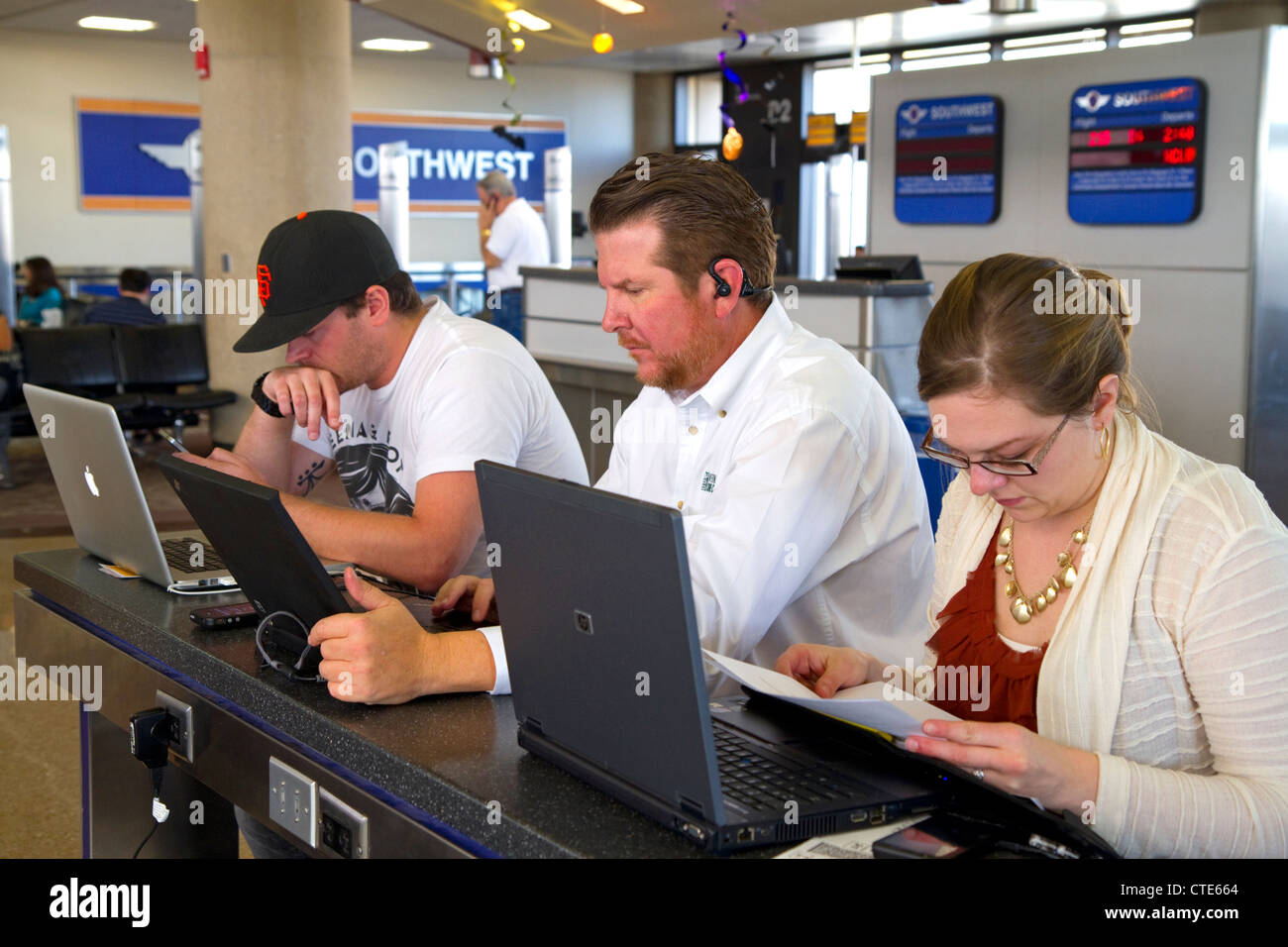 People use wi-fi internet at the Phoenix Sky Harbor International Airport located in the city of Phoenix, Arizona, USA. Stock Photo