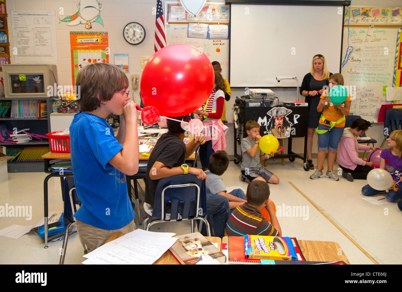 Student blowing up a balloon as part of a science experiment at a public elementary school in Brandon, Florida, USA. Stock Photo