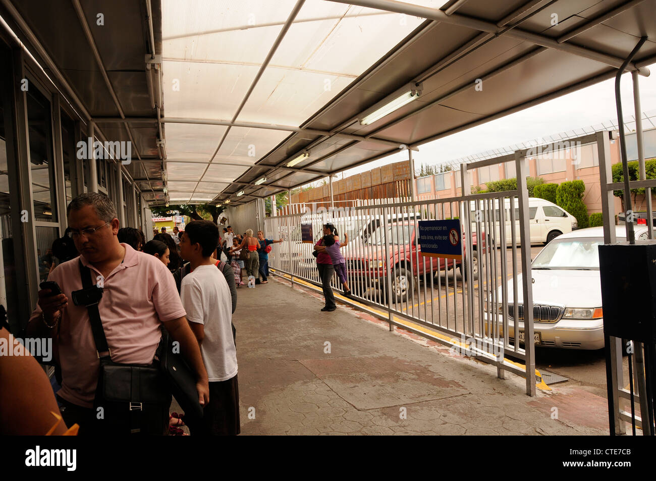 Border crossers wait in Nogales, Sonora, Mexico, to pass through customs to enter the United States at Nogales, Arizona. Stock Photo