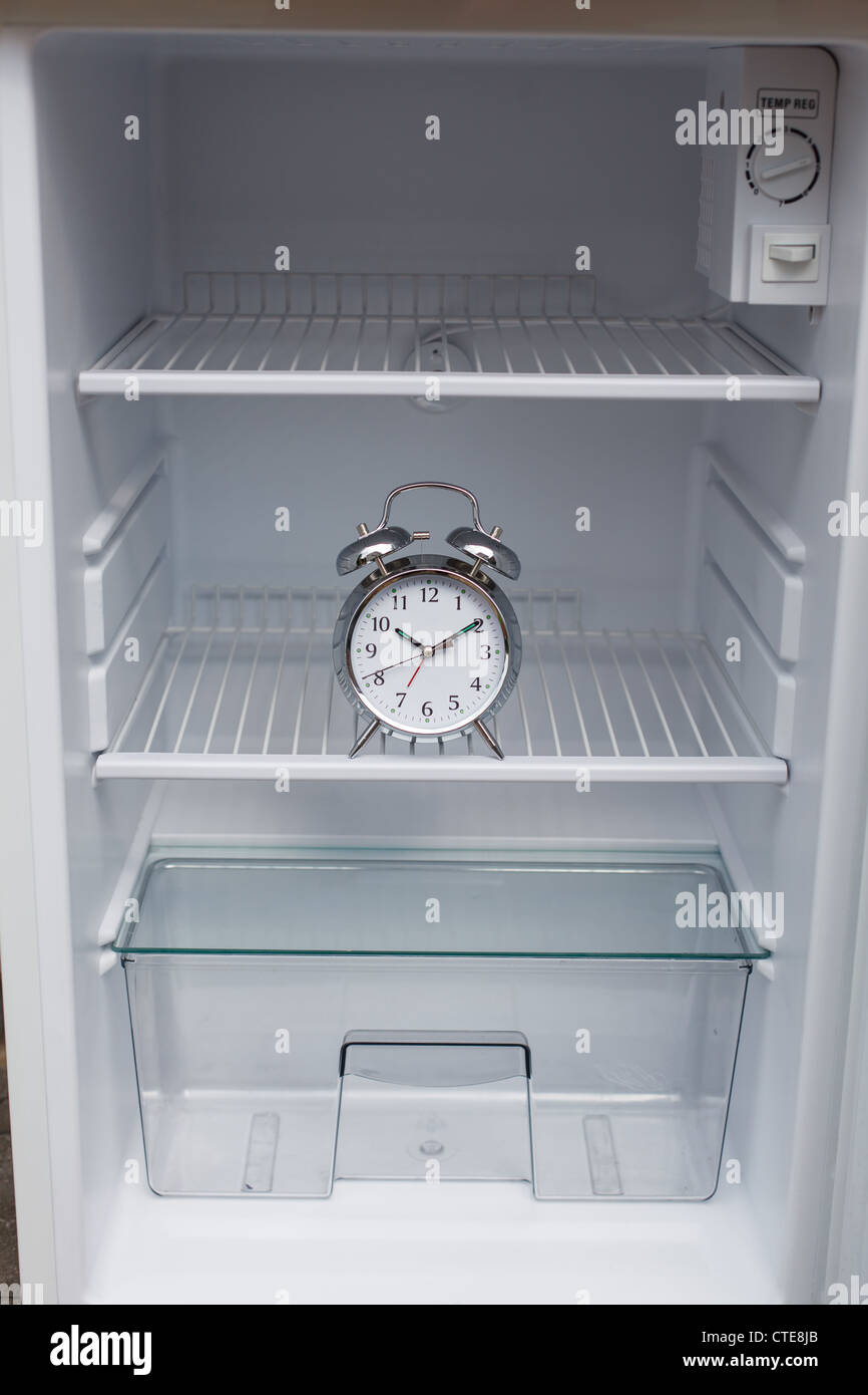 Noisy alarm clock hidden in a fridge Stock Photo - Alamy