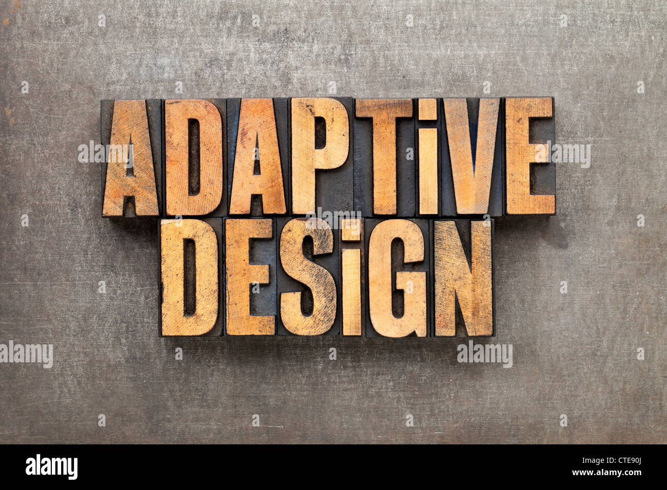 adaptive design - text in vintage letterpress wood type against grunge metal surface Stock Photo