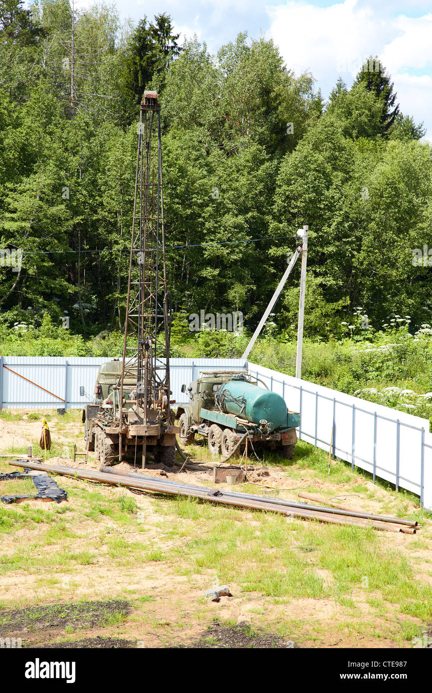 Drilling of a chink by derrick in the afternoon Stock Photo