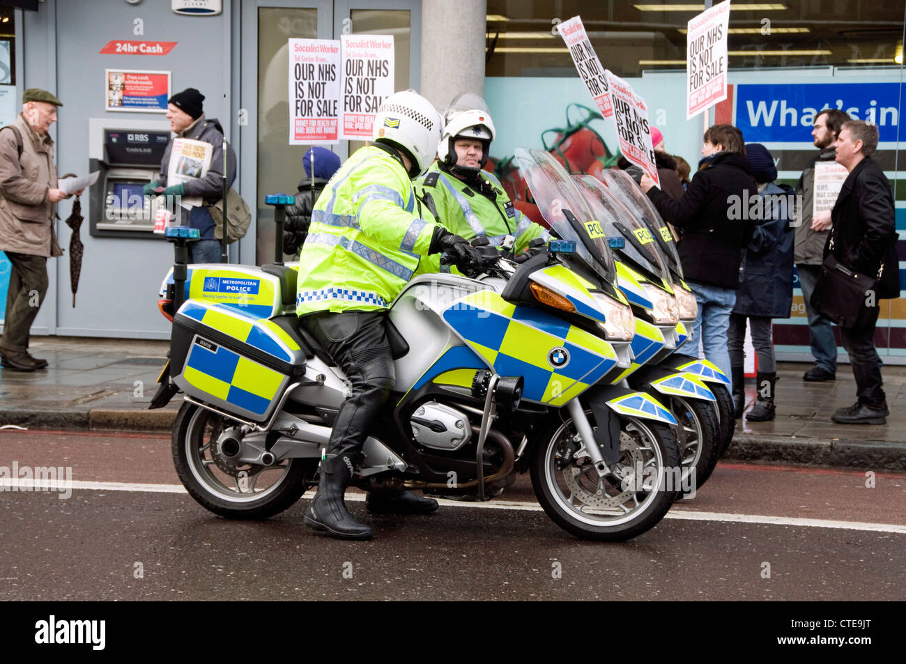 Three police officers on motorcycles at demonstration, Holloway Road, London Enland UK Stock Photo