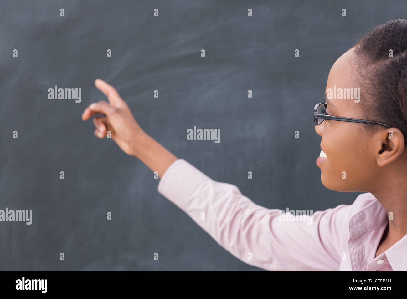 Black teacher pointing the blackboard Stock Photo