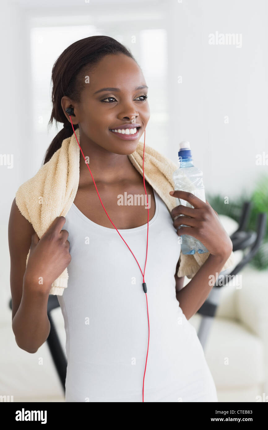 Black woman wearing a towel while holding a bottle Stock Photo