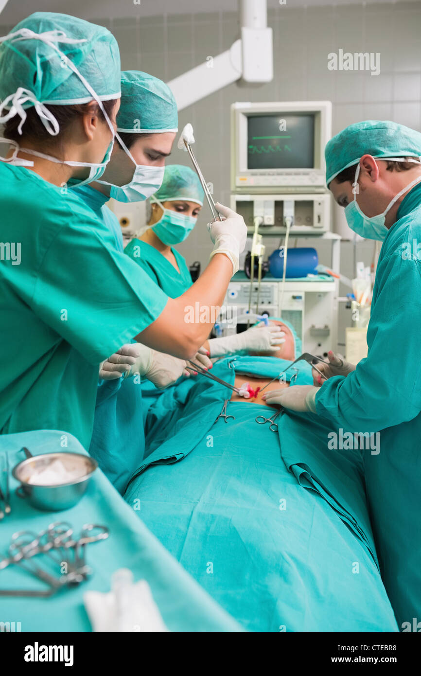 Nurse mopping the brow of a surgeon Stock Photo Alamy