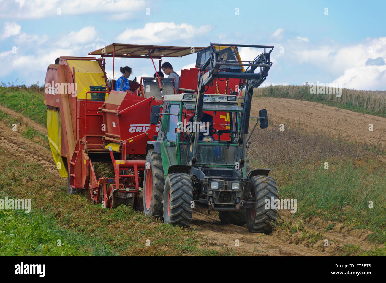 Potato Harvester Tractor harvesting murphy tater field rural scene German Agriculture