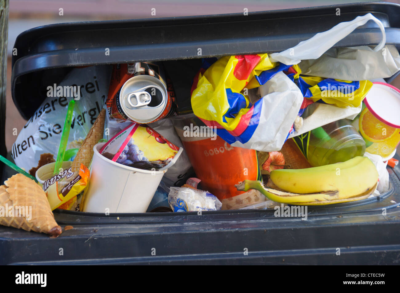 Cramped Trash Can Rubbish Bin Container full with garbage, rubbish, waste, abundance - Detail Stock Photo
