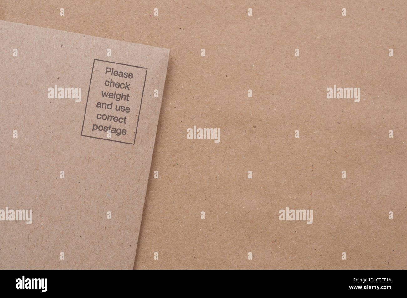 Postage required brown return envelope Stock Photo Alamy