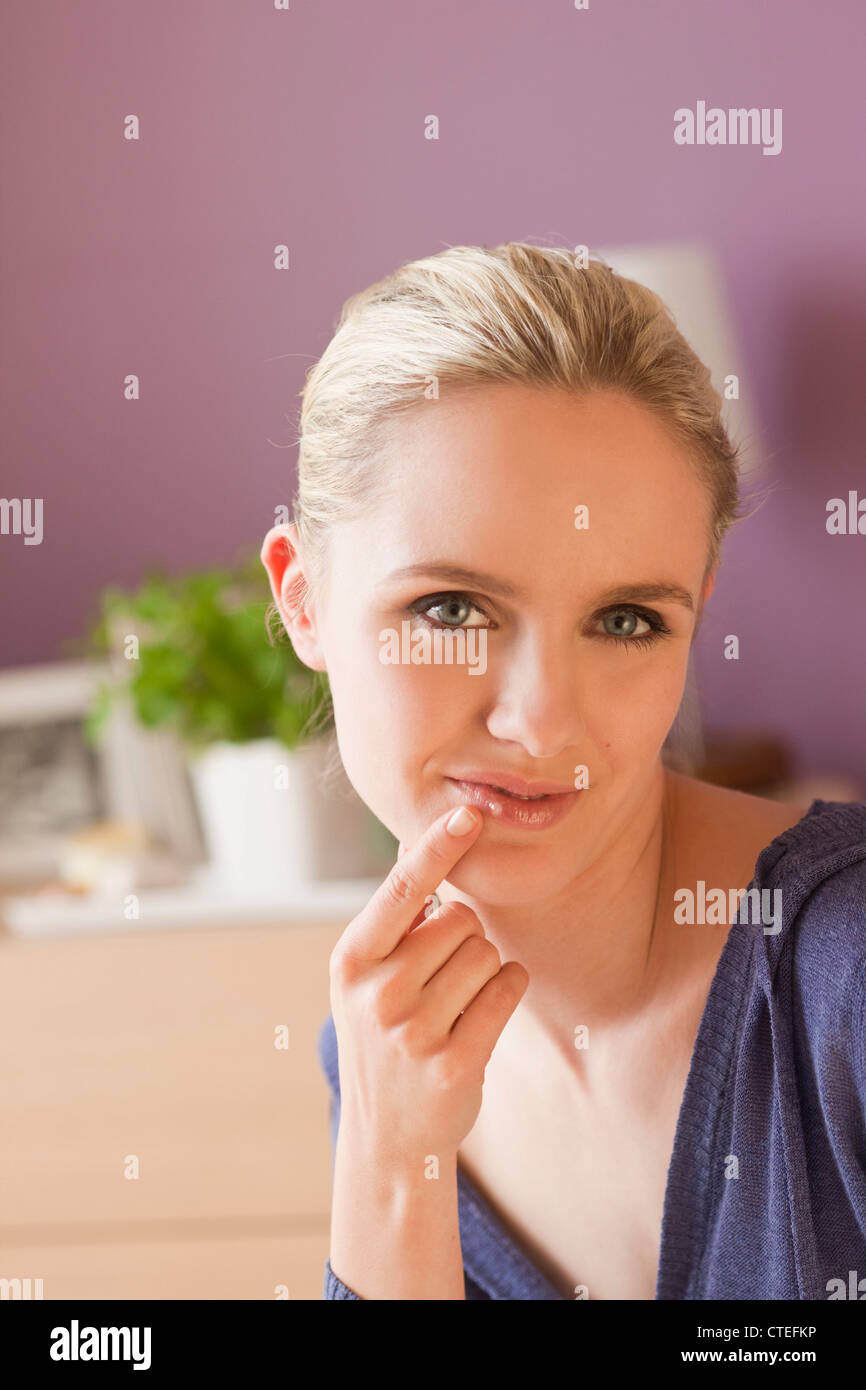 Woman applying ointment for cold sores Stock Photo