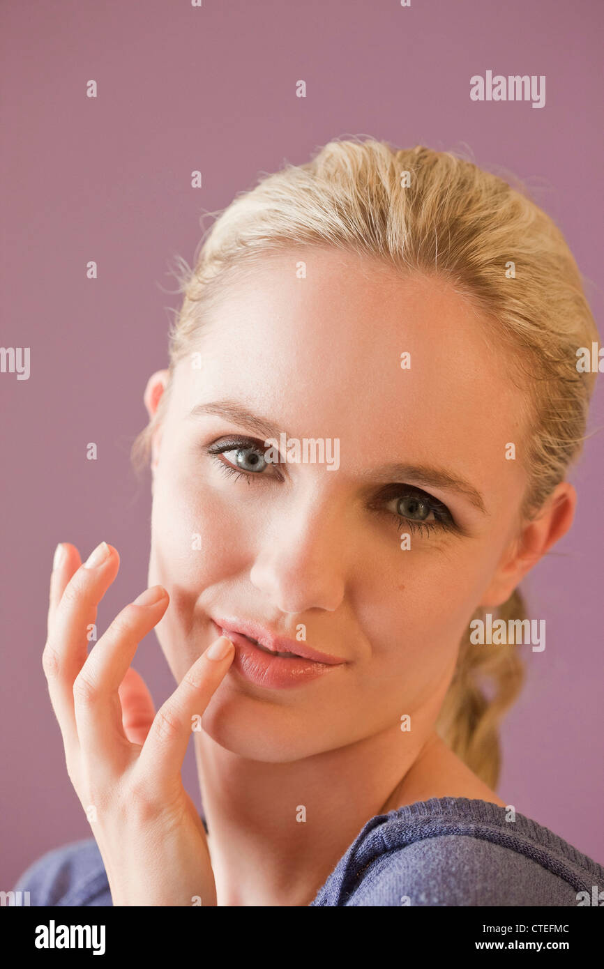 Woman applying cold sores patch Stock Photo