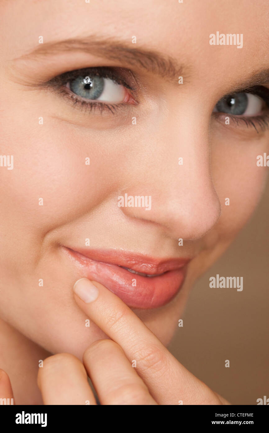 Woman applying cold sores patch Stock Photo