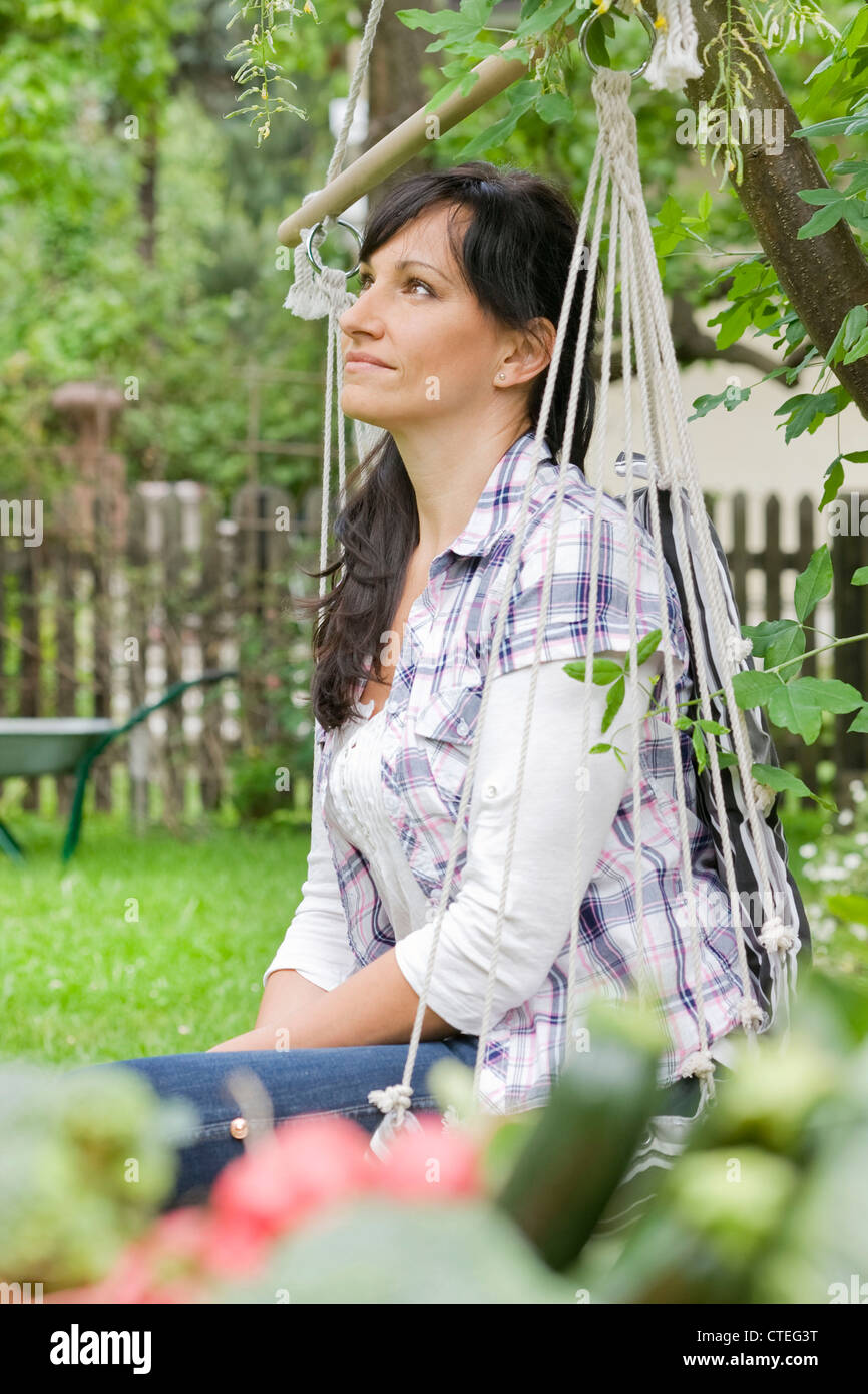 Woman relaxing in the garden Stock Photo - Alamy