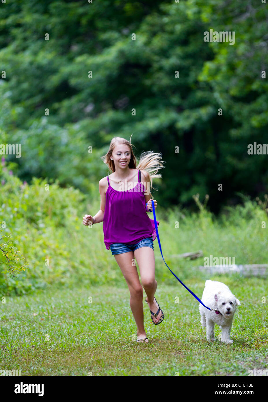 Teenage girl walking her dog Stock Photo - Alamy