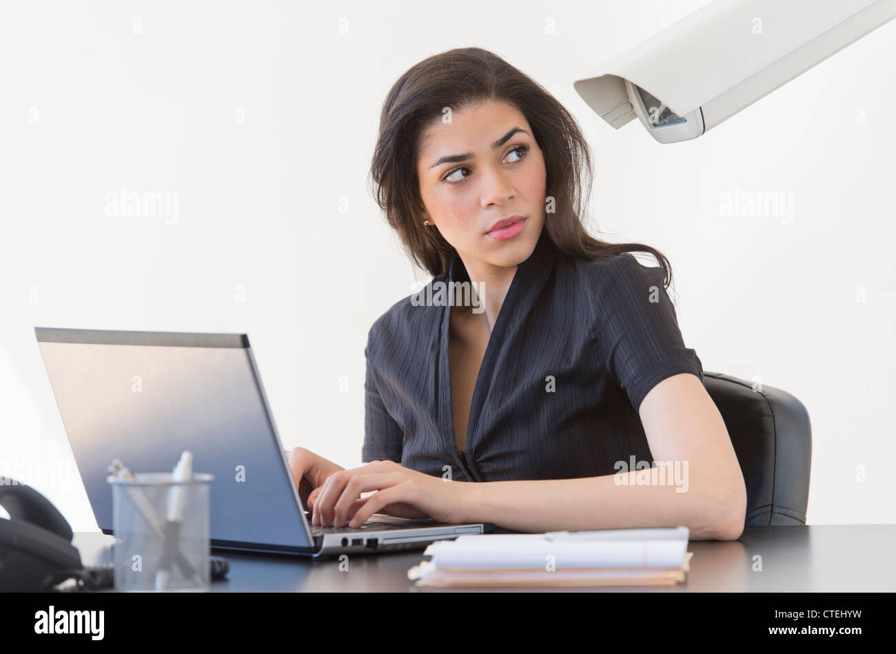 Businesswoman spied on by cctv camera Stock Photo