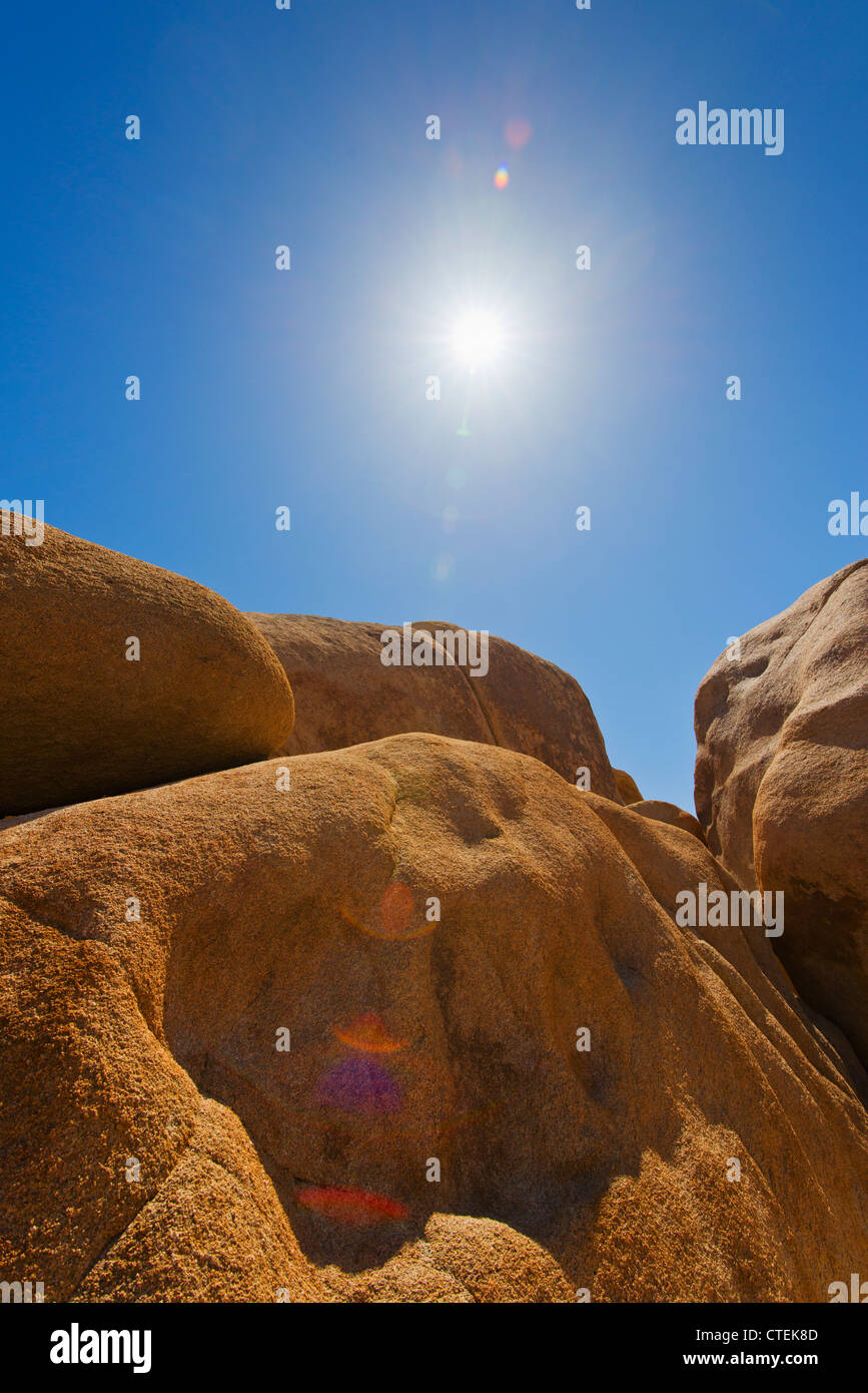 USA, California, Joshua Tree National Park, Desert rocks with solar flare Stock Photo