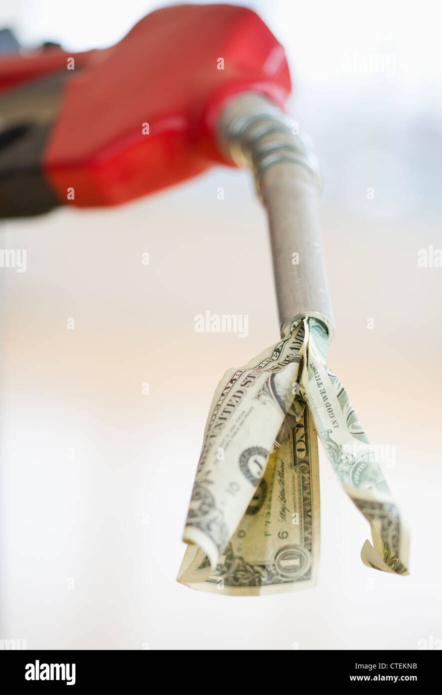 Fuel nozzle with dollar bill Stock Photo Alamy