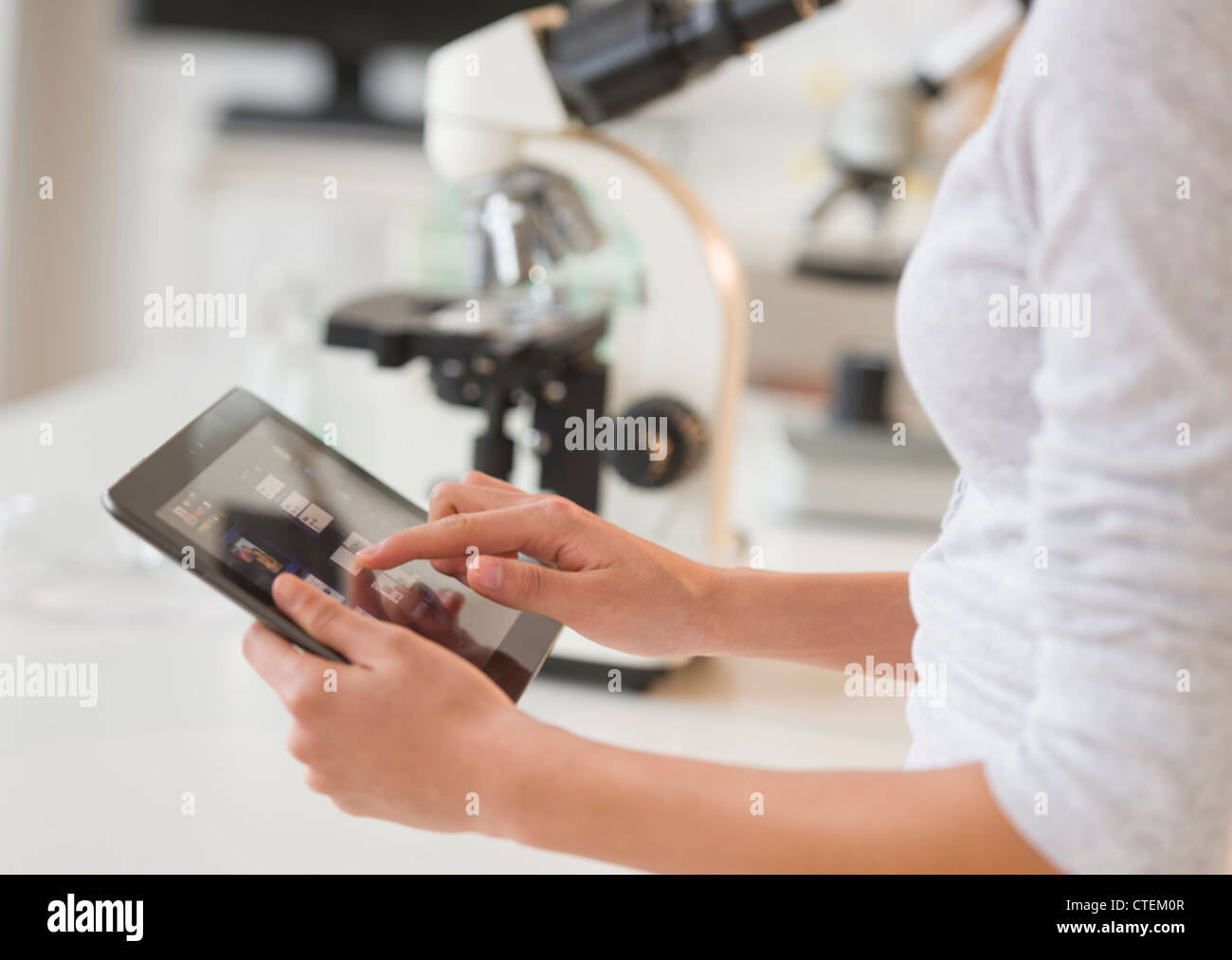 USA, New Jersey, Jersey City, Student (14-15) using tablet pc in chemistry lab Stock Photo