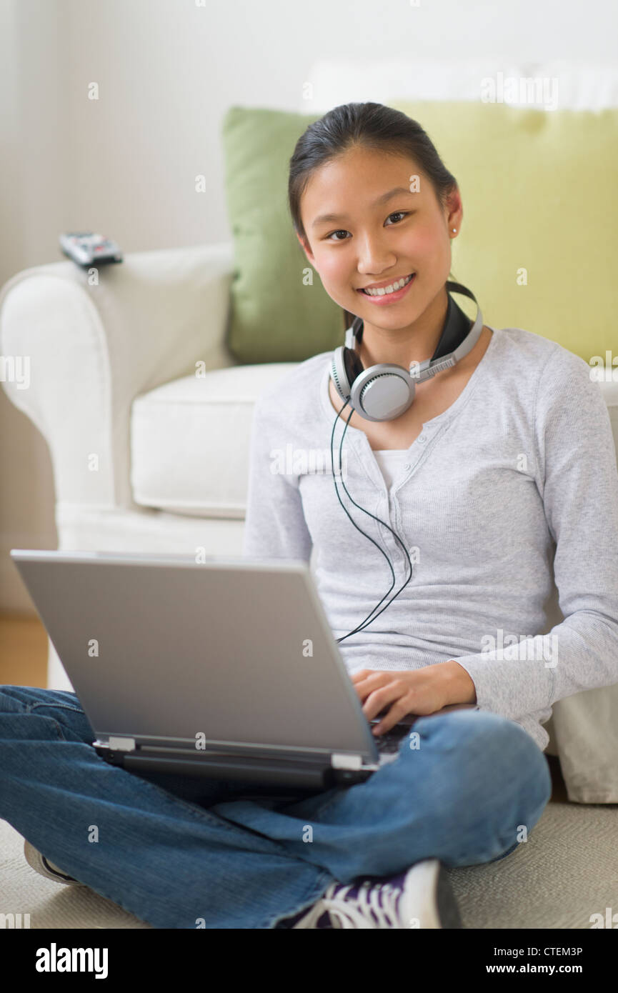 USA, New Jersey, Jersey City, Portrait of girl (14-15) using laptop at home Stock Photo
