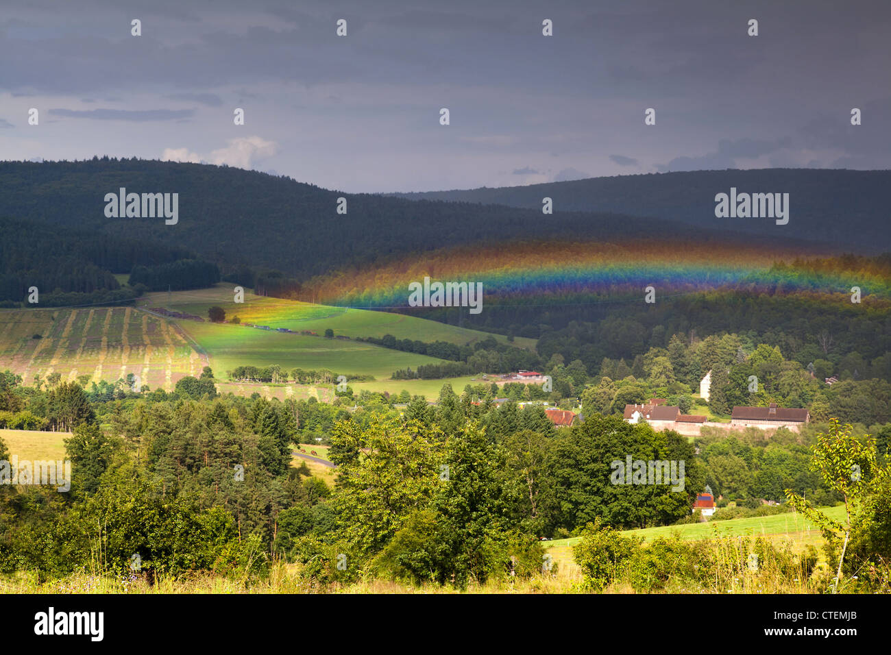 colorful rainbow after shower in mountains Stock Photo