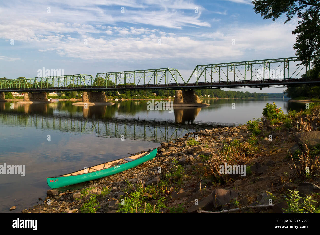 Bridge along the Delaware River with canoe on the river bank Stock Photo