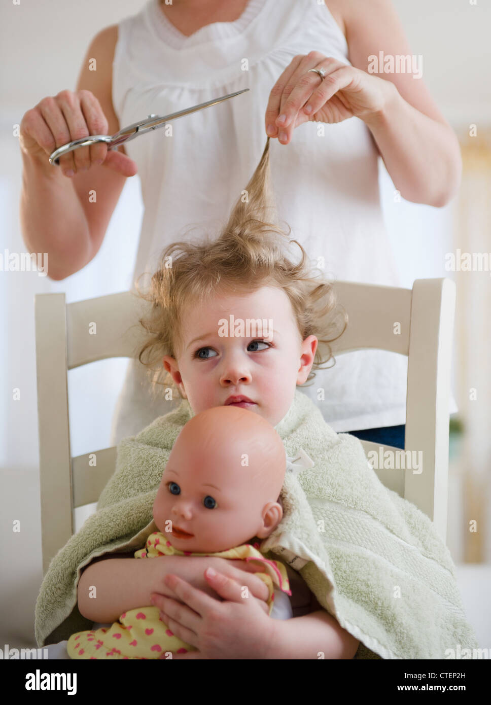 USA, New Jersey, Jersey City, Mother cutting daughter's (2-3) hair