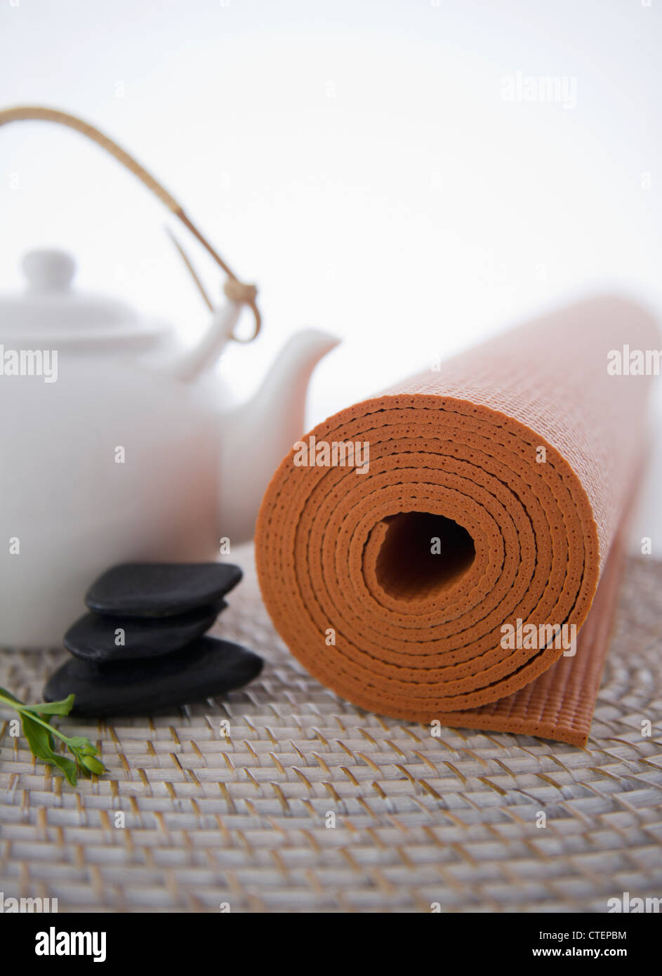 Still life with teapot, stones and yoga mat Stock Photo